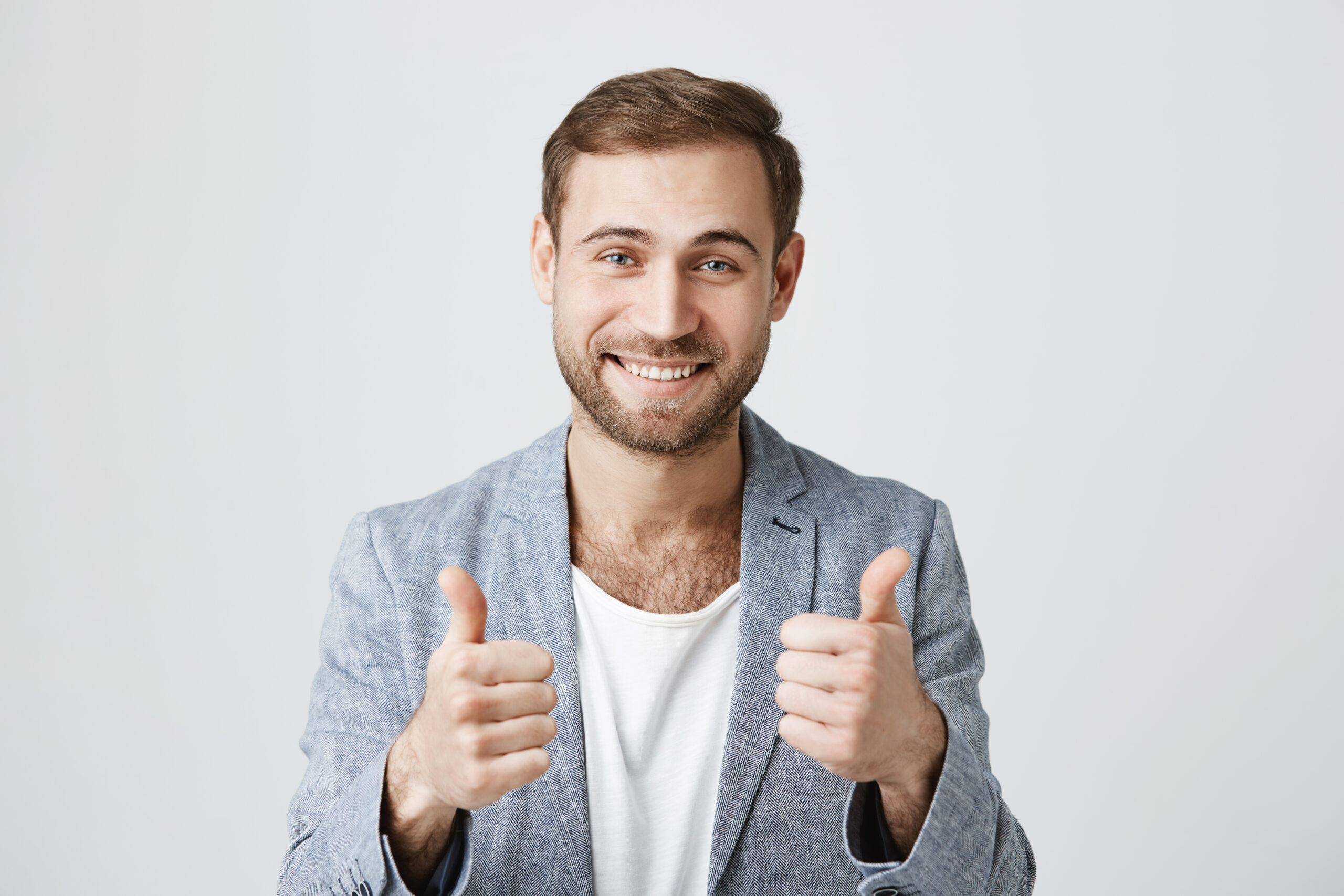 A smiling man in a black suit gives a thumbs-up, symbolizing trust and excellence in facility management services.