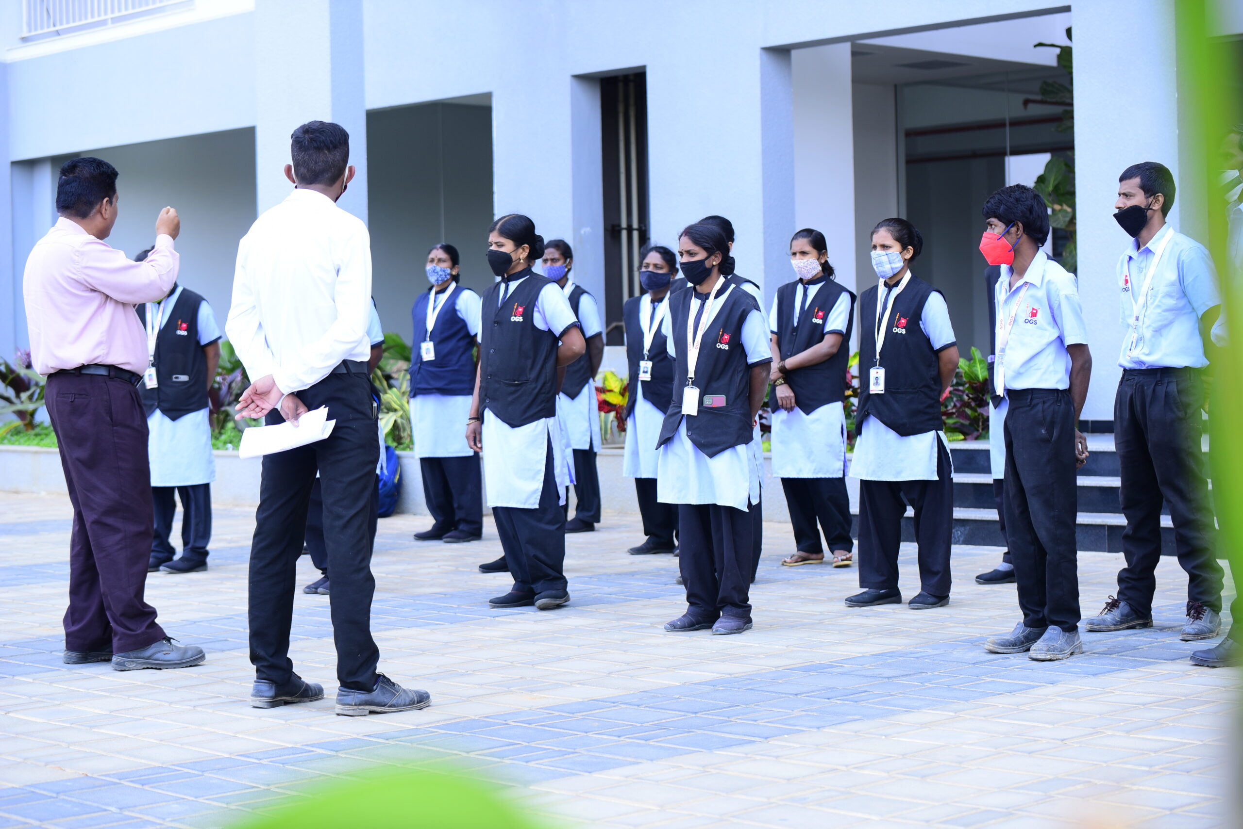 best facility management services in bangalore OGS Facility Management staff in uniform attending briefing session – delivering professional, reliable services across Bangalore.